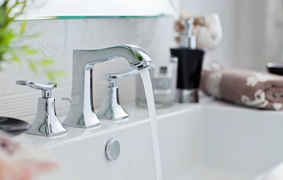 Hand testing bathroom faucet