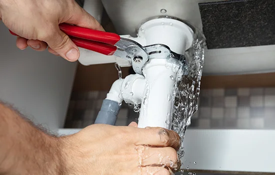 Plumber tightening pipe connection