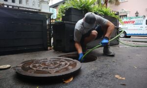 Technician cleaning outdoor drain