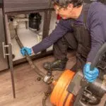 Plumber Cleaning Drain