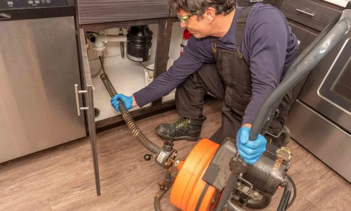 Plumber Cleaning Drain