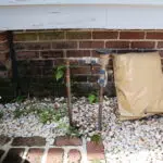 Outdoor backflow preventer setup at a Charleston home, showing irrigation system test and plumbing inspection site.