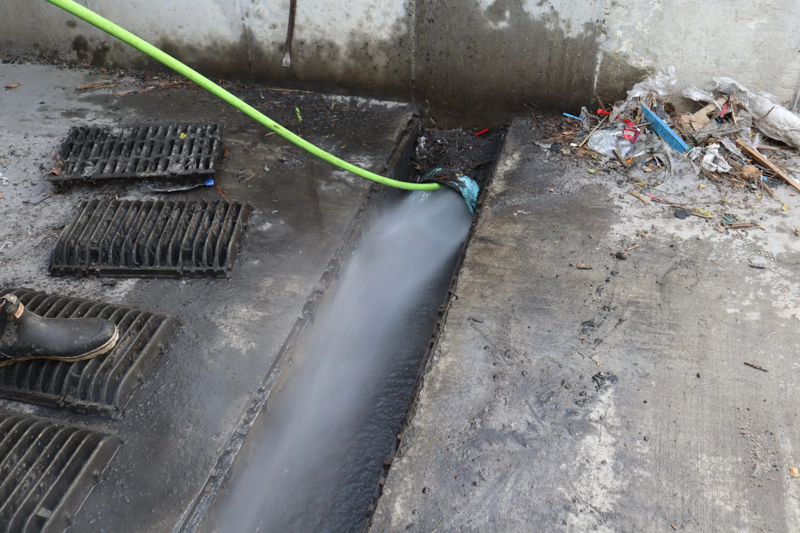 Commercial storm drain being hydro jetted by Rooter Man in Charleston SC to remove debris and restore flow
