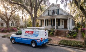 Rooter Man van parked outside old home