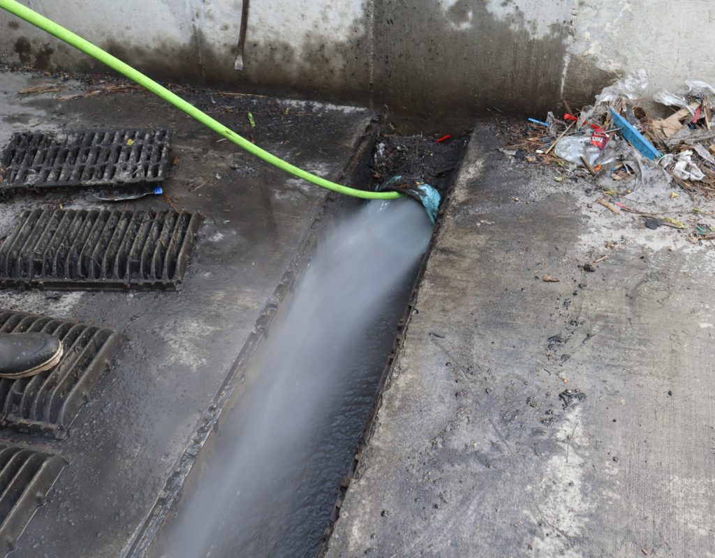 Commercial storm drain being hydro jetted by Rooter Man in Charleston SC to remove debris and restore flow